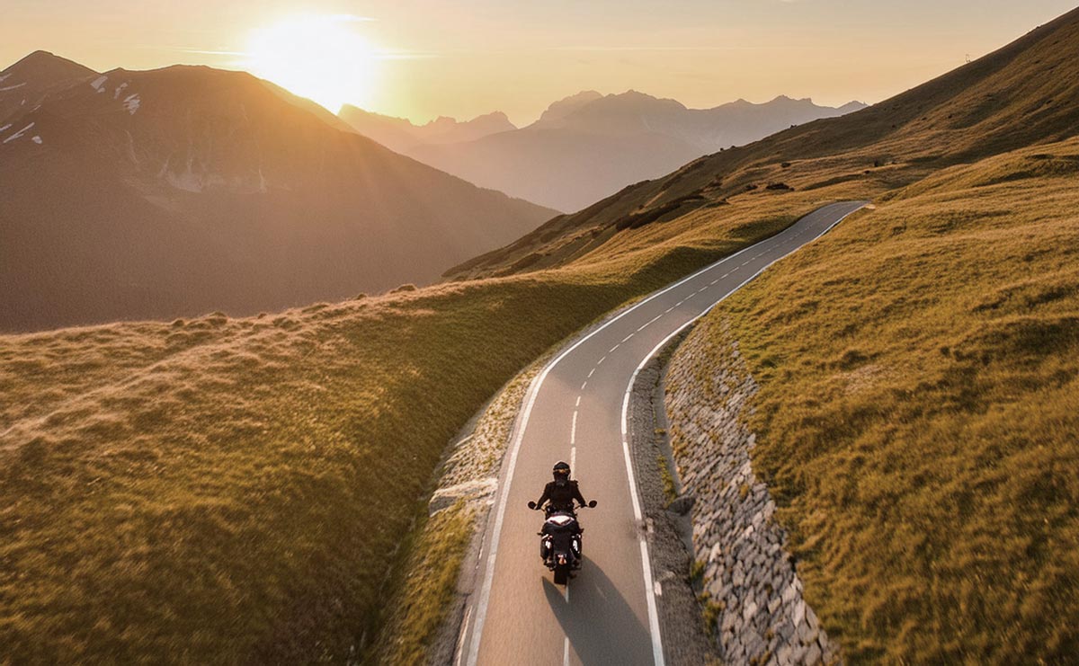 Firefly-wide-angle-drone-shot-of-motorcycle-driving-into-the-mountains-at-sunset-40233-opt